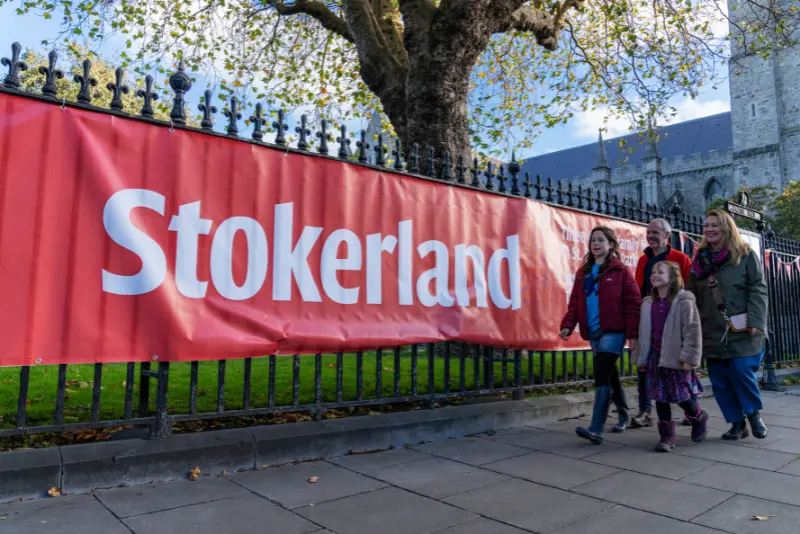 Families walking by the Stokerland banner near St Patrick’s Park, during the Bram Stoker Festival Dublin accommodation at The Dawson Hostel