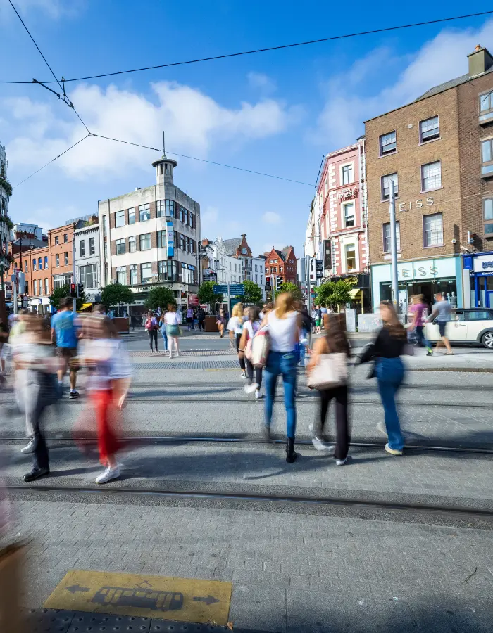 Shoppers crossing a busy Grafton Street in Dublin city centre, a short walk from The Dawson Hostel